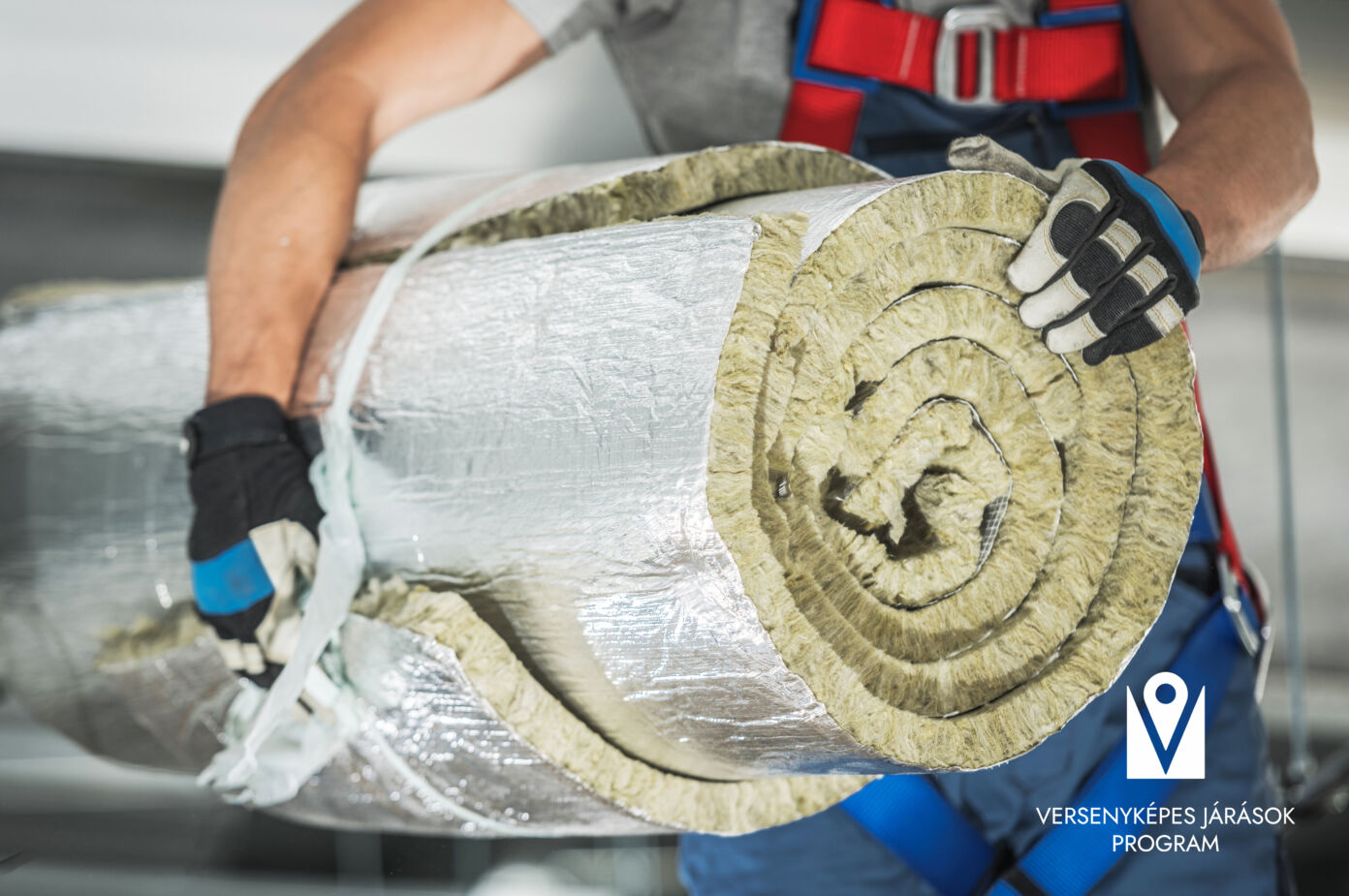 Contractor Worker with Roll of Mineral Wool Insulation