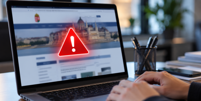 Laptop kijelzőjén piros figyelmeztető jelzés utal a kormányhivatalok honlapjának átmeneti elérhetetlenségére